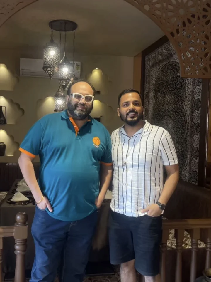 Dil Se Foodie photographed with his host beneath the carved arch in the dining room at Tajnuma, Agra