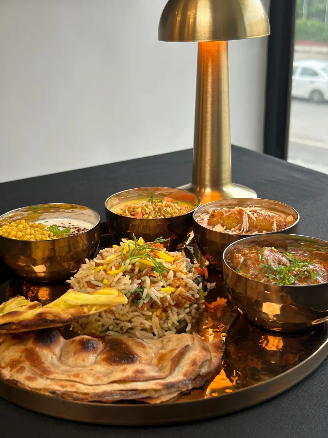 A vegetarian dish plated on copper at Tajnuma, Agra