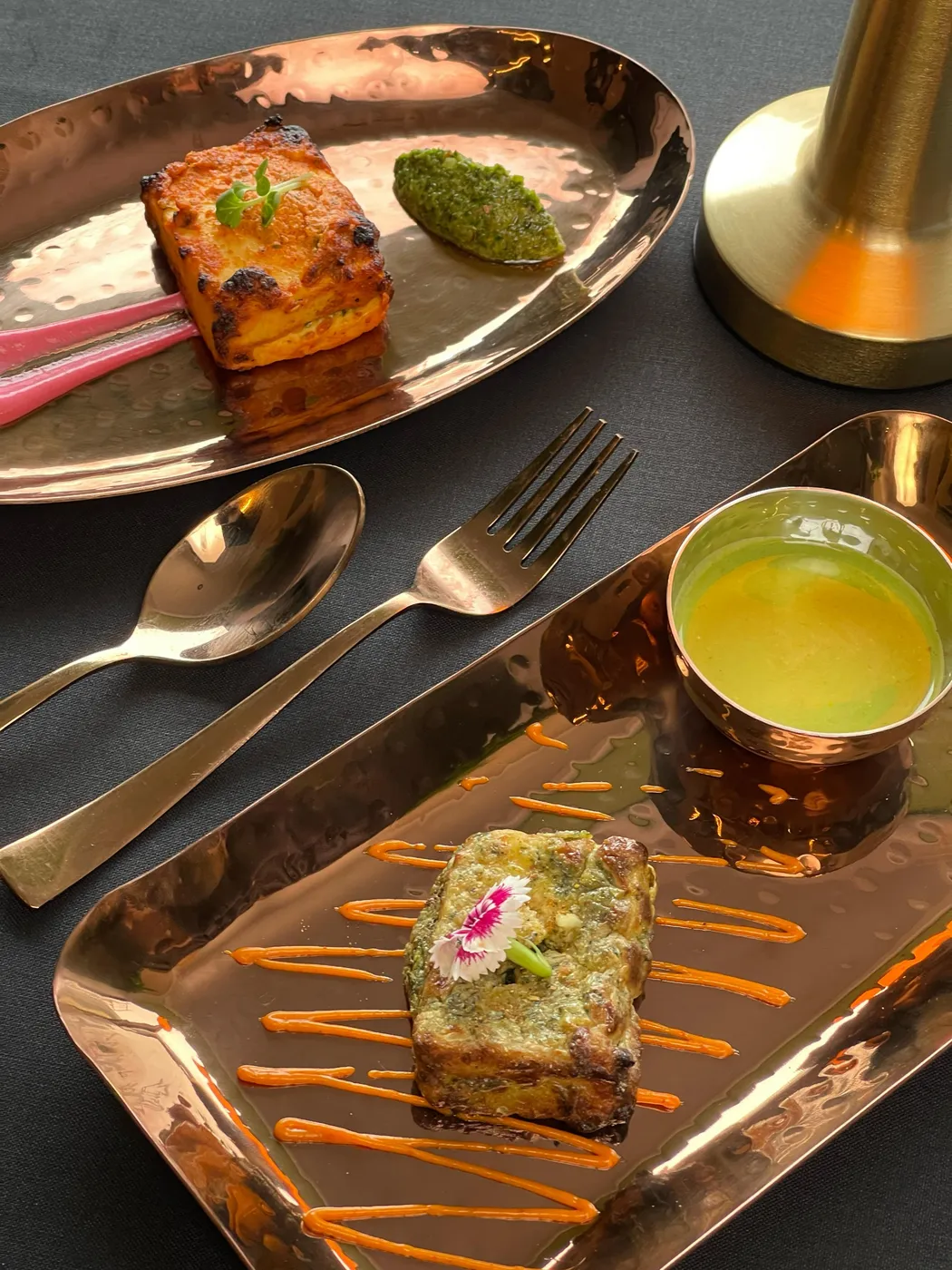 A vegetarian dish plated on copper at Tajnuma, Agra