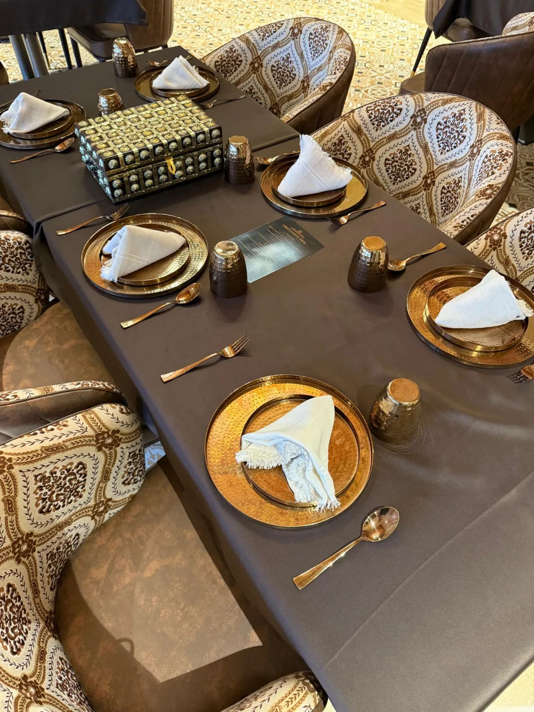 The dining room at Tajnuma, Agra, laid for service