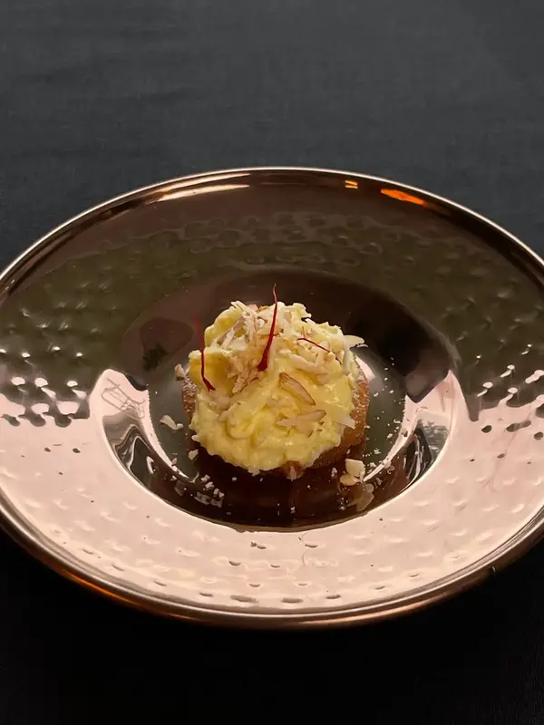 A course served in a deep copper bowl. Tajnuma, Agra.