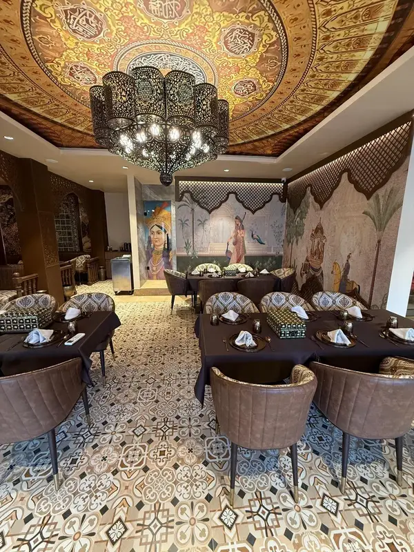 A hand-painted ceiling medallion and crystal chandelier. Tajnuma, Agra.